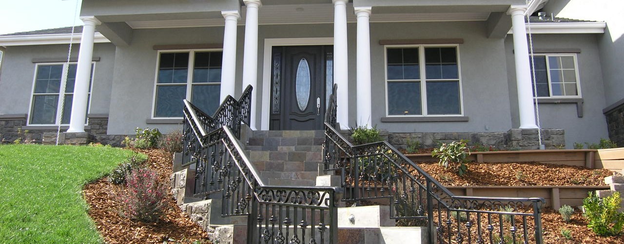 Custom Home With Tiled Staircase and Iron Railing